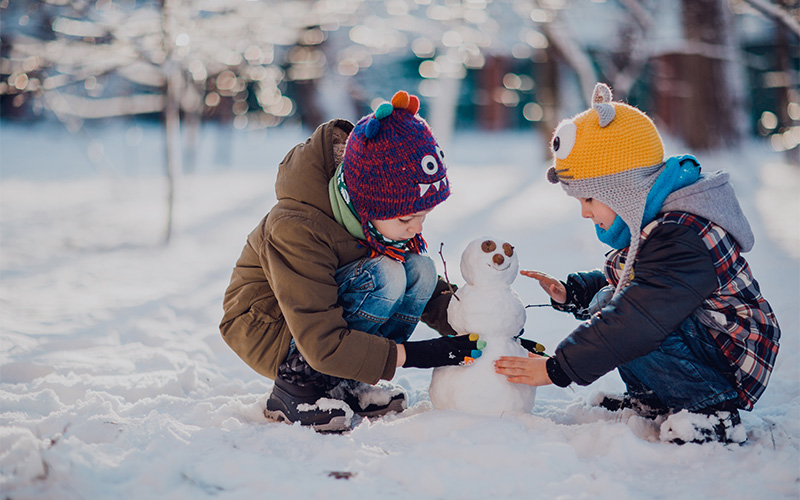Kids playing with snow in French Alps